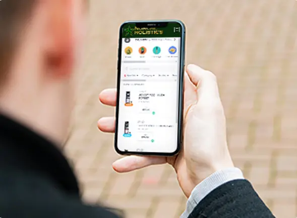 A hand holding a phone showing the Norcal Holistics online menu.
