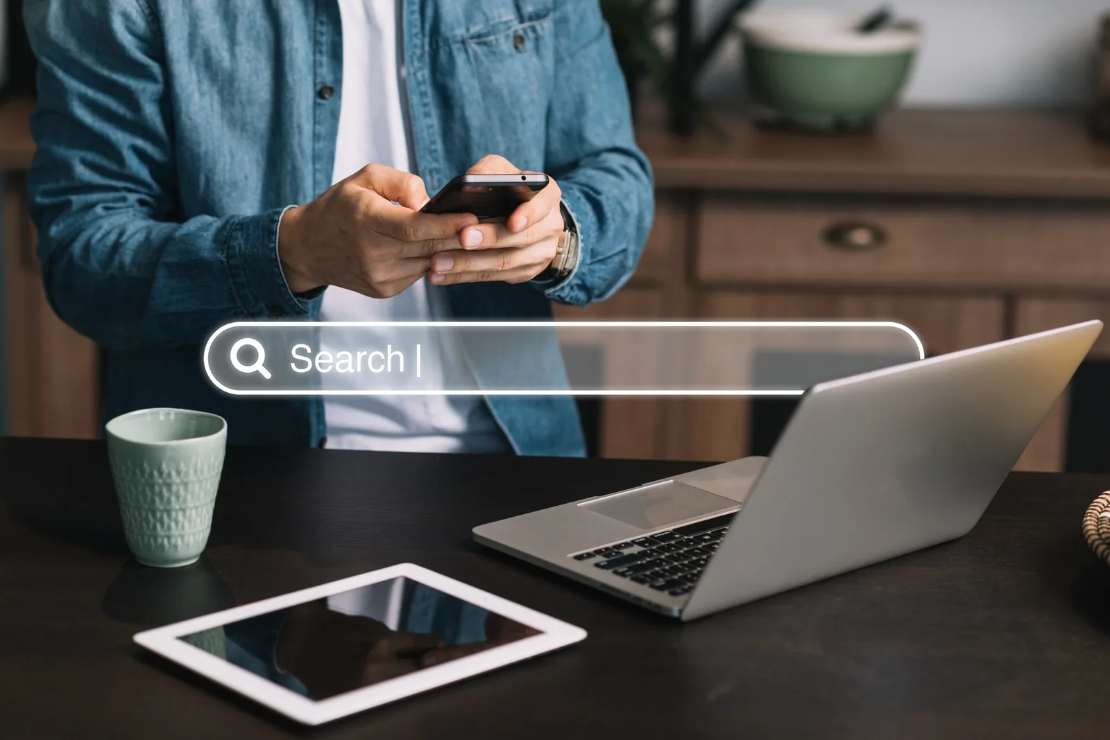 SEO specialist reviewing search results on a phone beside a laptop and tablet